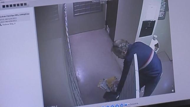 Security camera footage shows a suspect stealing personal information in an unsecured mail room.